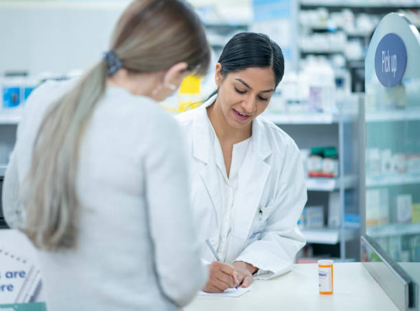 istock Pharmacist Giving Patient Instructions stock photo 1205632955