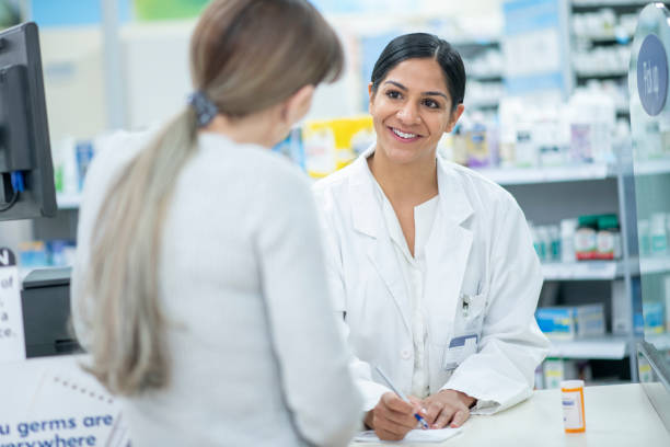 Pharmacist Giving Patient Instructions stock photo