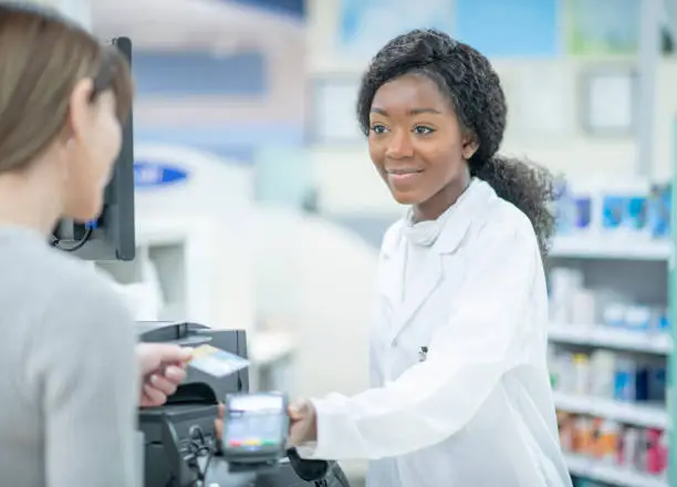 Photo of Pharmacist Cashing Out A Customer stock photo