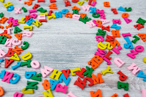istock multicolored letters on a gray wooden background 1205636877