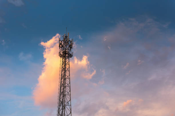 istock Communication Antenna Tower for Telecommunication Network Against Blue Sky Background on Sunrise. Technology Cellular and Transmission Connection of Telecom, Satellite Broadband Structure Station. 1205637824