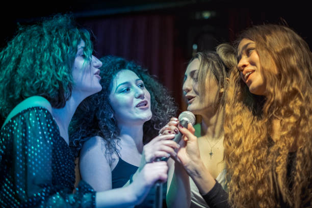 istock Girls are at karaoke party 1205638448