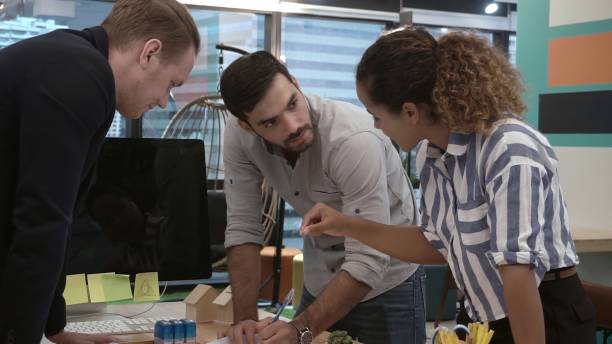 istock Creative business people group having conversation at office desk in workplace. 1205639648