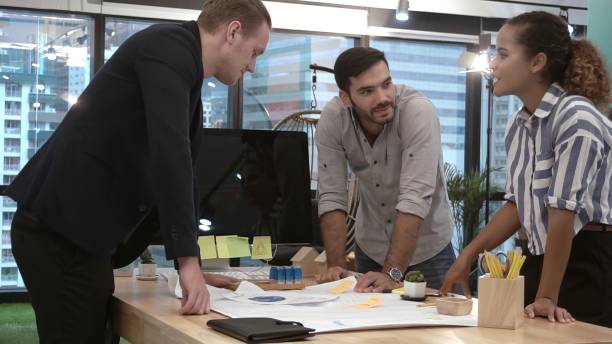 istock Creative business people group having conversation at office desk in workplace. 1205639669