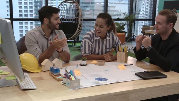 istock Creative business people group having conversation at office desk in workplace. 1205640905