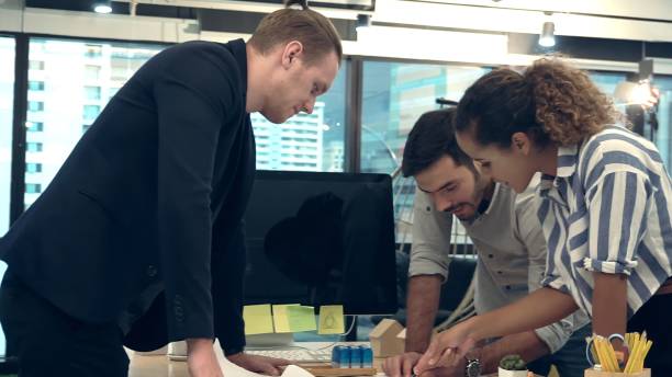 istock Creative business people group having conversation at office desk in workplace. 1205640913