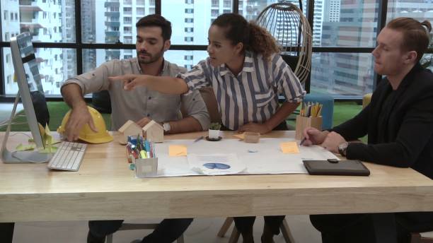 istock Creative business people group having conversation at office desk in workplace. 1205640953