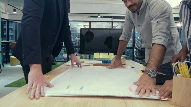 istock Creative business people group having conversation at office desk in workplace. 1205640968
