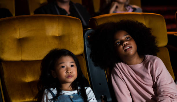 istock Two children having fun and enjoy watching movie 1205641288