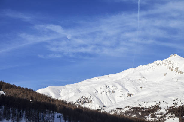 istock Snowy off piste slope in high winter mountains 1205642435