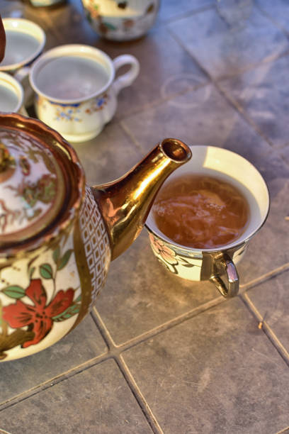 istock a cup of black tea with teapot in the background 1205647109