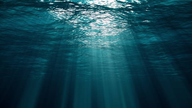 istock Underwater view with sunbeams shining and creating god rays in the deep sea 1205648755