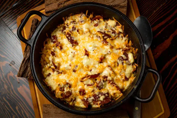 Photo of BBQ Side of Melted Mac and Cheese in a Cast Iron Bowl and Plated