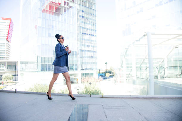istock Latina executive woman walking to work 1205649808