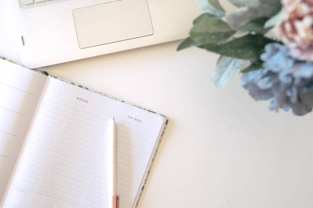 istock Girl boss working space with laptop, flowers and journal 1205649823