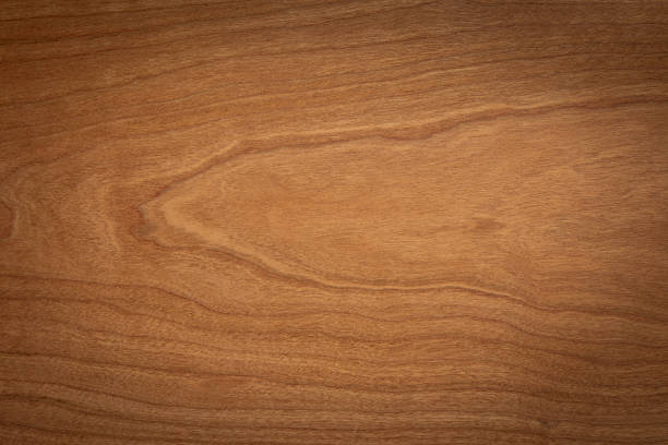 istock Walnut color wooden board texture background.  Dark tone cherry wood plank background. Texture element. 1205653916