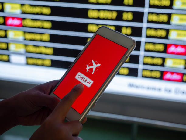 istock Flight check-in by mobile phone. Hand touching on smartphone screen to check-in for a flight. 1205659393