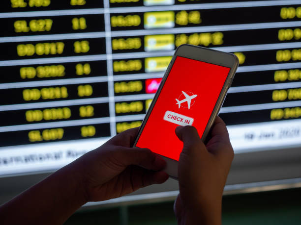 istock Flight check-in by mobile phone. Hand touching on smartphone screen to check-in for a flight. 1205659398