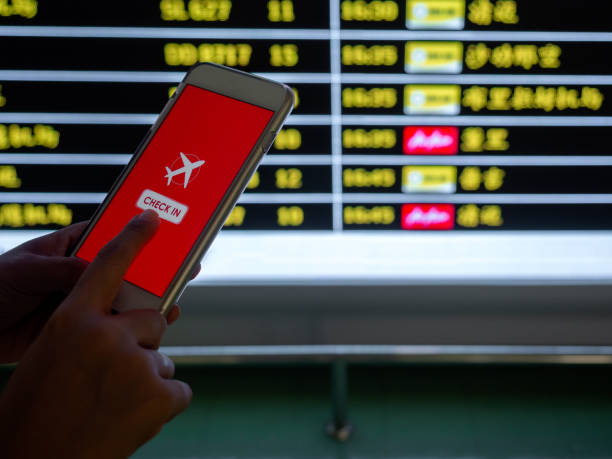 istock Flight check-in by mobile phone. Hand touching on smartphone screen to check-in for a flight. 1205659411