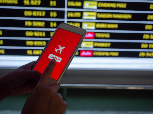 istock Flight check-in by mobile phone. Hand touching on smartphone screen to check-in for a flight. 1205659434
