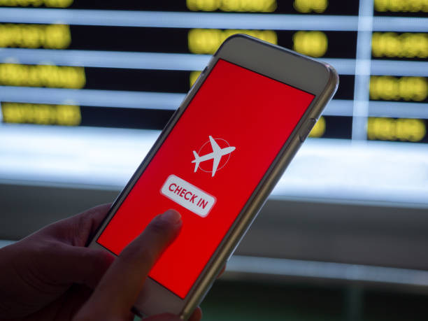istock Flight check-in by mobile phone. Hand touching on smartphone screen to check-in for a flight. 1205659437