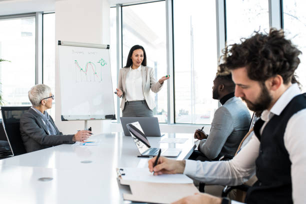 istock A young competent analyst presenting a graph to the company's team at the conference room. 1205663659