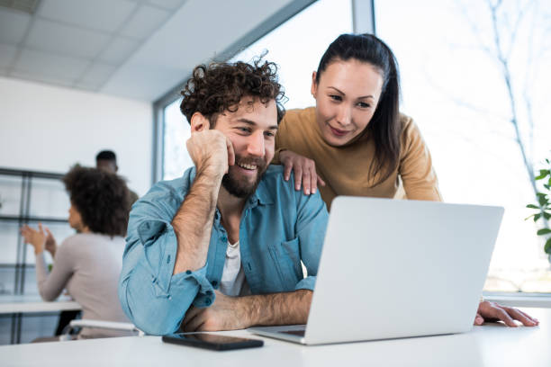 istock A manager and a subordinate looking at his latest design, happy with the results. 1205664762