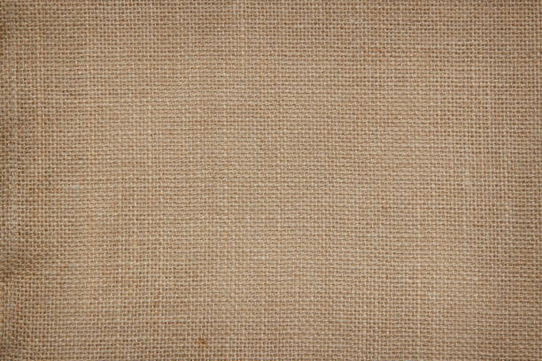 istock Brown Hemp rope texture background. Sackcloth or blanket wale linen wallpaper. Rustic sack canvas fabric texture in natural. Haircloth vintage linen burlap weaving, Old beige carpet background. 1205667045