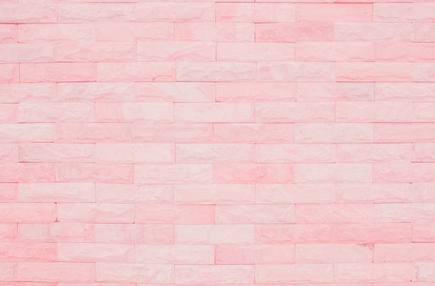 Seamless Pink pastel pattern of decorative brick sandstone wall surface with concrete of modern style design decorative uneven have cracked realmasonry wall of multicolored stones or blocks white cement.