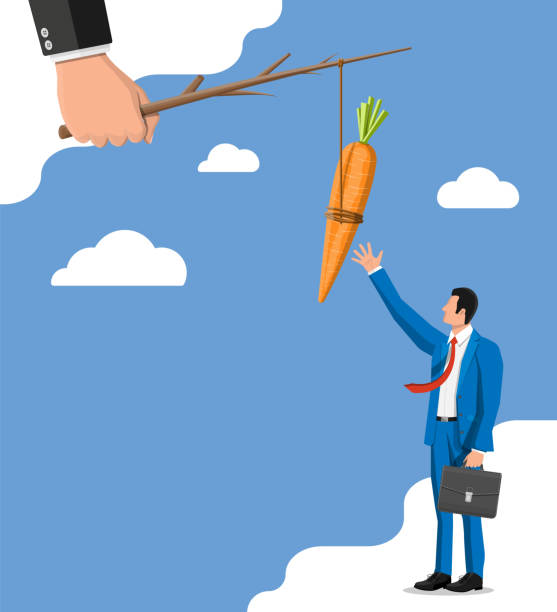 istock Carrot on a stick in hand and businessman. 1205669791