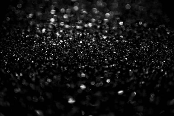 istock Glittering black and white bokeh background 1205669797