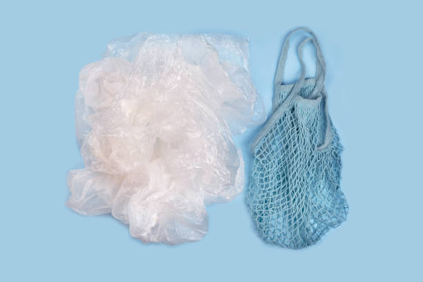 istock String reusable bags and a pile of plastic bags 1205669860