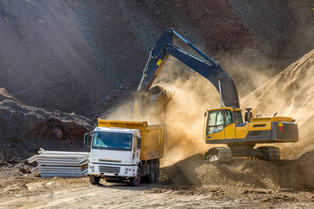 istock The excavator is digging and loading excavation to dump truck in construction field. Excavators (hydraulic) are heavy construction equipment consisting of a boom, dipper (or stick), bucket and cab. 1205671673