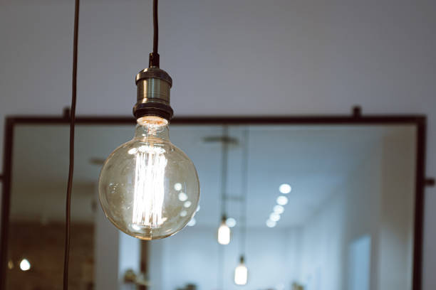 istock Indoor decoration lamp bulb isolated on a blurry mirror background 1205671811