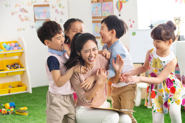 istock Kindergarten teachers and children embrace together 1205673012