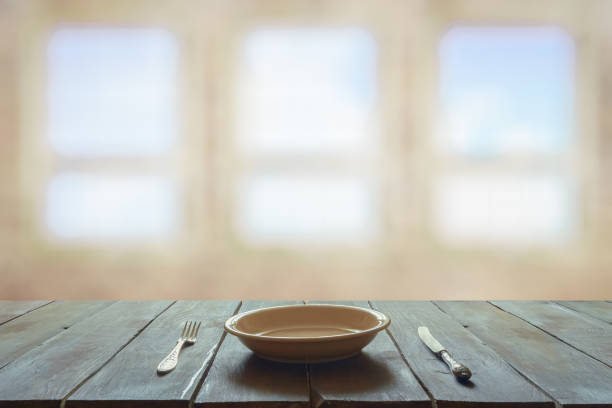istock plate with fork and knife on wooden table 1205677488