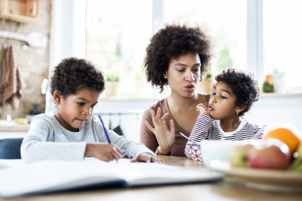 istock We won't bother your brother until he finishes his homework! 1205679413