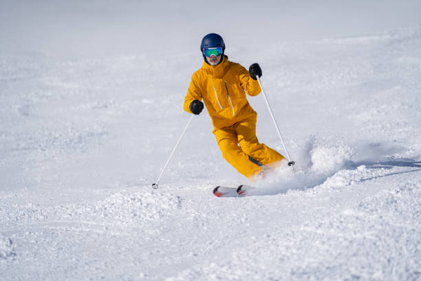 istock skilled skier skiing in short turns on ski slope 1205679458