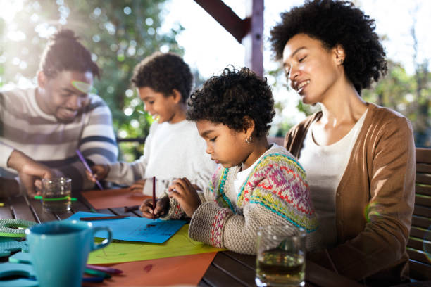 istock Happy black family enjoying while drawing together on a balcony. 1205680201