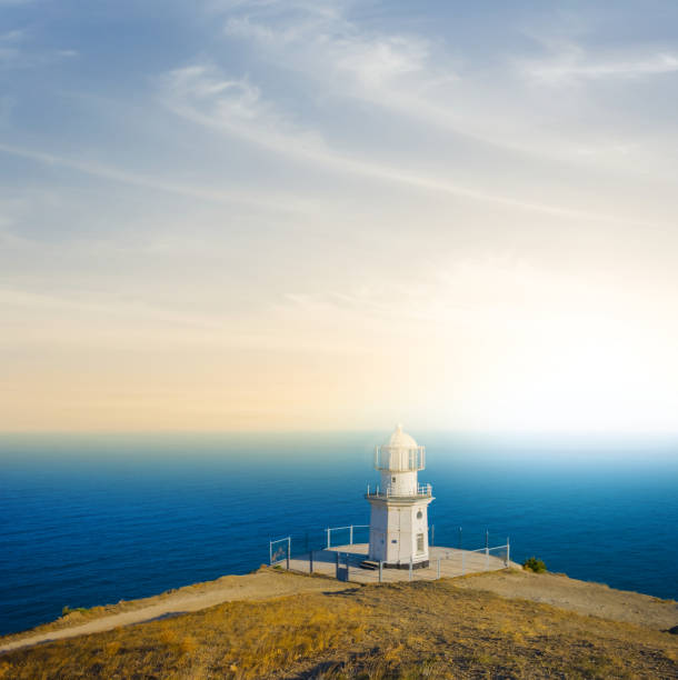 istock lighthouse on a hill above a sea 1205680693