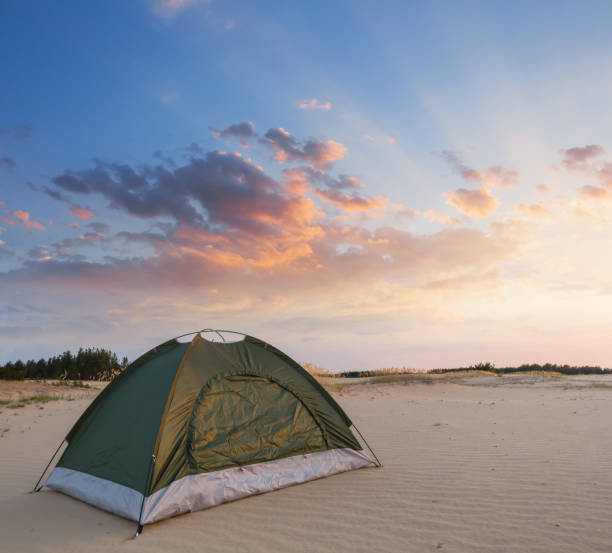 istock green touristic tent on a sand 1205680794