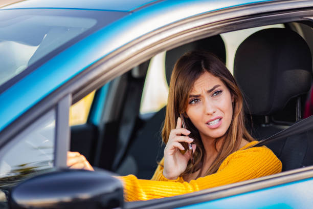 istock Disappointed woman driving car, talk while driving 1205681678