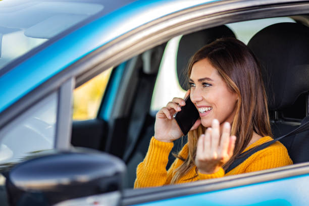 istock Distracted woman talking on her phone while driving. 1205681694