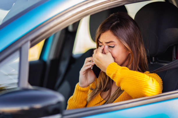 istock Disappointed woman driving car, talk while driving 1205681828