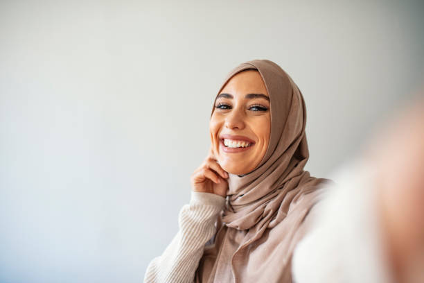 istock A young beautiful and modern muslim woman taking selfie. 1205682092