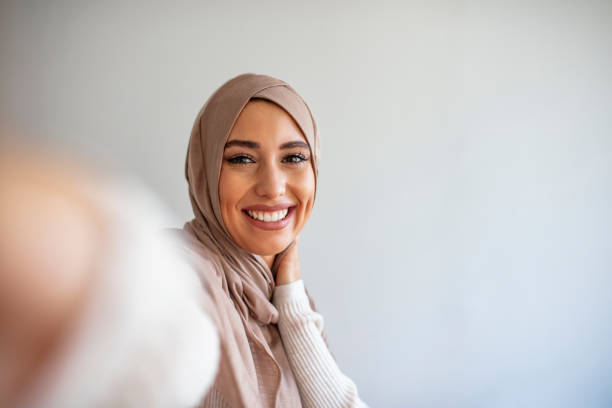istock A young beautiful and modern muslim woman taking selfie. 1205682121