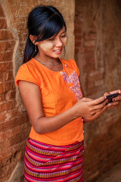 istock Young Burmese girl using a mobile phone in Bagan, Myanmar 1205683100