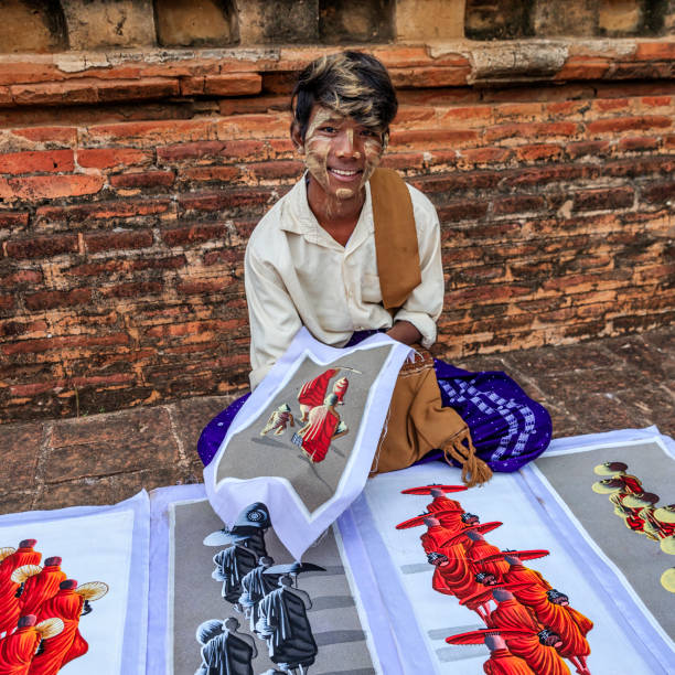 istock Young Burmese boy selling sand paintings in Bagan, Myanmar 1205683510