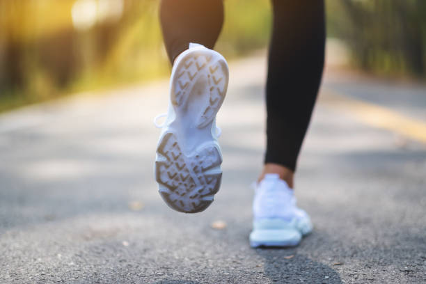 istock a woman's legs while jogging in city park in the morning 1205684572