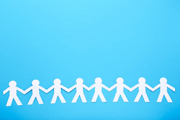 istock Paper chain people on blue background 1205685625